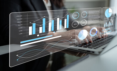 A modern business professional analyzes data using a laptop while engaging with holographic charts...