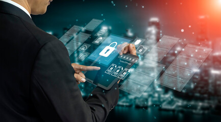 A businessman interacts with a digital tablet displaying security icons and data analytics, symbolizing modern technology and data protection in a digital landscape. Gantry