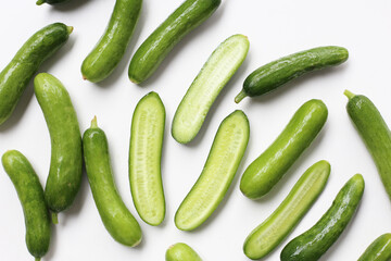 Fresh mini baby cucumbers on white background