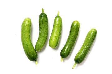 Fresh mini baby cucumbers on white background
