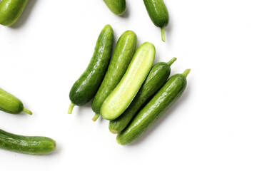Fresh mini baby cucumbers on white background