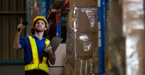 Warehouse worker using barcode scanner and clipboard to check inventory on shelves. Concept of inventory inspection, logistics accuracy and efficient warehouse management system.