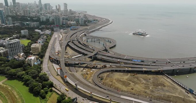 Morning view of the Mumbai Coastal Road in Maharashtra, India, famously known as the 'City of Dreams.' The scene captures a multileveled interchange roadway. A complex road network and urban design.