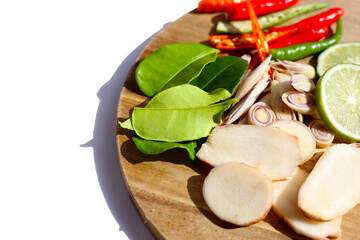 Fresh Tom Yum ingredients laid out on wooden cutting board.