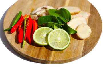 Fresh Tom Yum ingredients laid out on wooden cutting board.