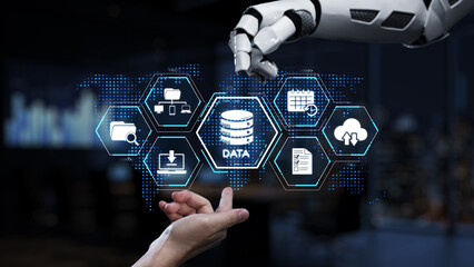 A robotic hand interacts with virtual data icons in a modern office setting, showcasing the integration of technology in data management and innovation processes. Synapse