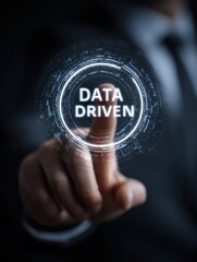 Fototapeta premium businessman touching a futuristic interface with the words data driven in the center symbolizing data analysis and decision making