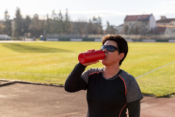Athlete woman drinking water
