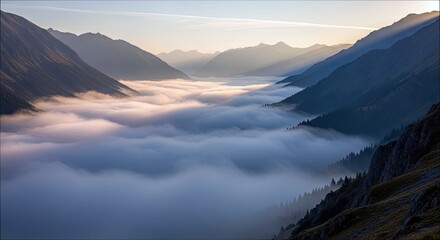 A scenic landscape featuring mountains and a valley filled with clouds at sunrise. The image captures a serene and peaceful atmosphere.