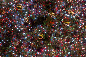 Festive dark theme with red background decorated with Christmas lighting, balls, green Christmas...