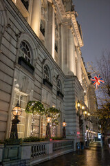Walking on streets of Central London in Covent Garden decorated with Christmas lighting and green Christmas trees with garlands, December holidays in England