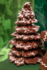 Christmas cookies, decorated with icing and chocolate gingerbread Christmas tree on display in confectionery shop in London, UK