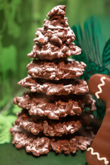 Christmas cookies, decorated with icing and chocolate gingerbread Christmas tree on display in confectionery shop in London, UK