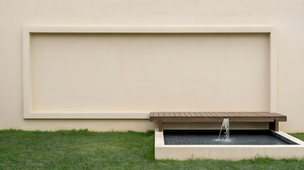 A serene outdoor scene featuring a small water feature with a gentle stream flowing into a basin surrounded by lush green grass and a neutral toned wall