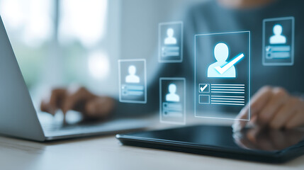 Person using laptop and tablet interacting with digital profiles hands