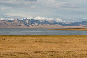 View of Song Kul Lake in the Tian Shan Mountains. In the background the Song Kul Too Mountains. Naryn region. Kyrgyzstan. Asia.