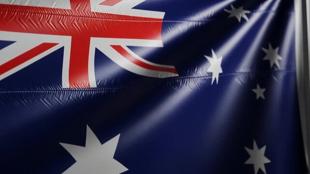 Closeup of the Australian national flag waving with deep blue fabric texture and visible stars