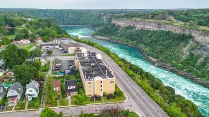 Fototapeta premium Aerial view of Niagara Falls river in summer with lush greenery and sparkling flowing water
