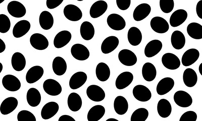 Monochrome seamless pattern of scattered black ovals or seeds on a white background