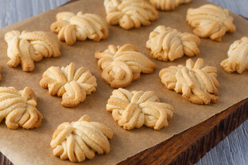 Freshly baked butter spritz cookies on baking paper