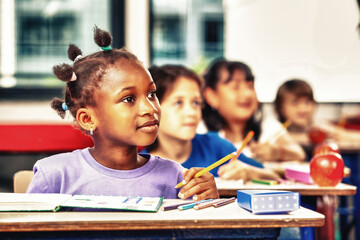 Elementary school classroom with diverse group of children attentively listening to a lesson