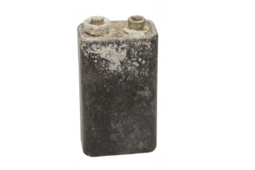 Older 9-volt battery showing corrosion on terminals and body, symbolizing decay, power loss, and obsolete technology