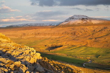 Winter sunlight on snowcapped Ingleborough in The Yorkshire Dales, England, UK.