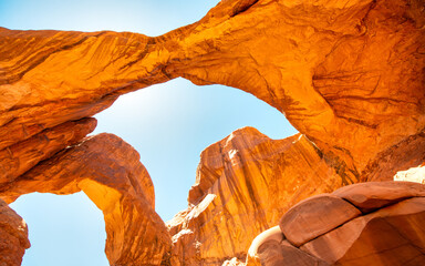 Scenic view of Double Arch red sandstone rocks under clear blue sky in Arches National Park