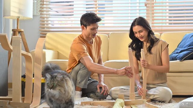 Young asian couple assembly a new furniture at home