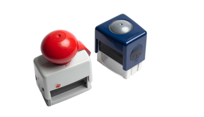 Two colorful, rectangular, and round-topped office tools rest against a stark, black backdrop