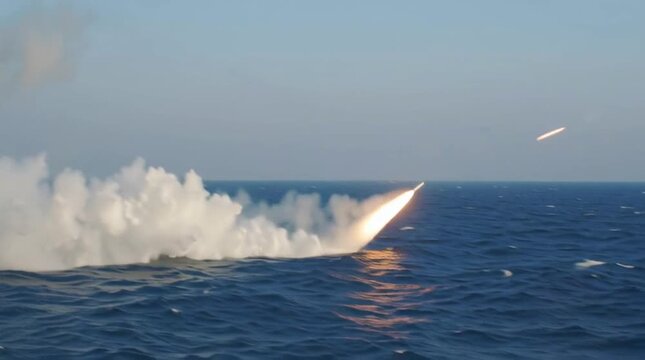 Frigate launches two rockets from its deck. Warship attacks. War in the ocean. Navy operation