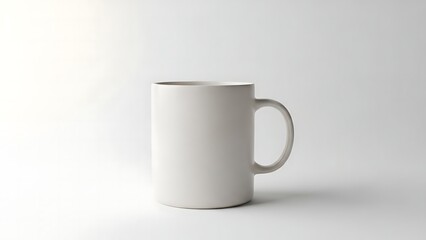 Fototapeta premium Simple white ceramic mug with handle on a white background