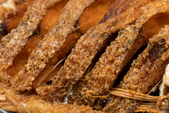 Crispy fried ruby fish showcasing its golden crispy texture and appetizing details in a close-up view.