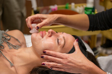 Woman enjoying rejuvenating facial cupping spa treatment