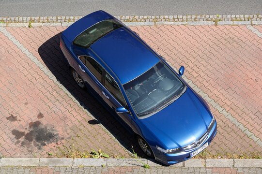 Top view of blue Honda Accord 7G sedan CL7 car parked on street, with oil spills