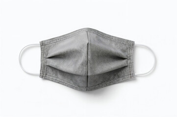 Close up of a grey patterned cloth face mask on a white background