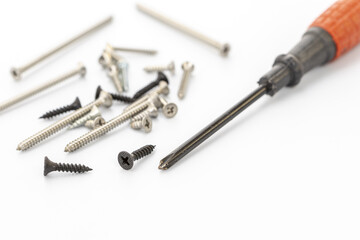 Assorted Screws and Screwdriver on a White Background for DIY Projects