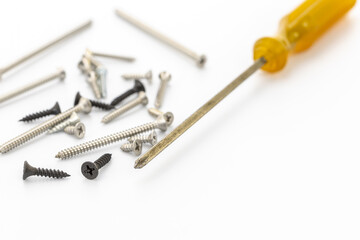 Close-up of Screws and Screwdriver on a White Background for DIY Projects