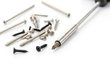 Variety of Screws and Screwdriver on White Background