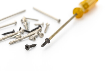 Close-up of Screws and Screwdriver on White Background