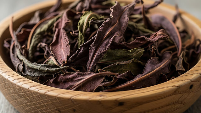 A bunch of dried fermented Rosebay willowherb leaves in a wooden bowl Close-up from a low angle 55518448 1