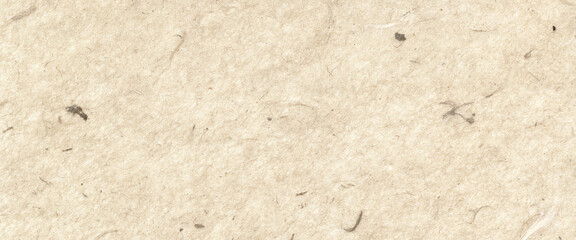 Neutral close up of natural paper texture with fiber and speckles. Recycled craft paper surface background. Eco friendly concept for stationery, design, mockup
