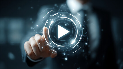 Initiating the Digital Age: A focused individual initiates the digital process of streaming media, pointing at the play button with modern technology, signifying the starting of a new video.