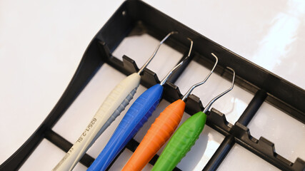 A set of silicone-handle dental composite instruments arranged neatly in a dental instrument tray