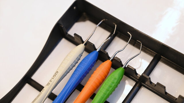 A set of silicone-handle dental composite instruments arranged neatly in a dental instrument tray