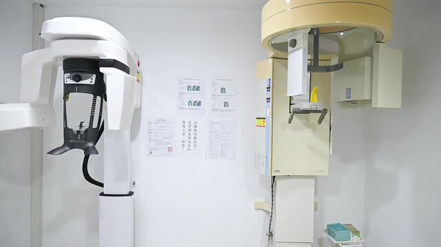 Two dental X-ray machines in the radiography room, filmed with a horizontal camera move