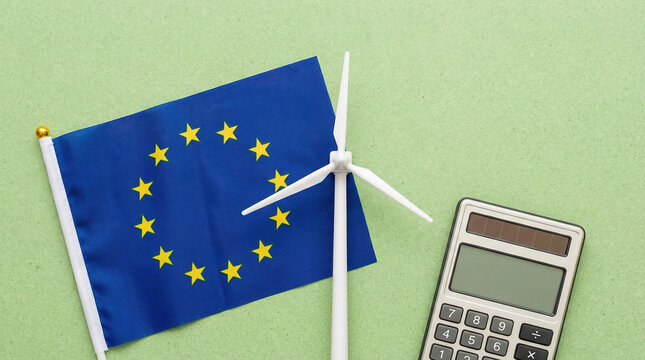 European Union flag with wind turbine model and calculator on green background
