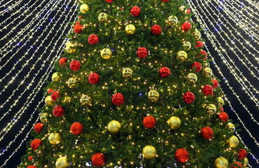 Christmas tree decorated with red and golden christmas balls. New Year, festive background