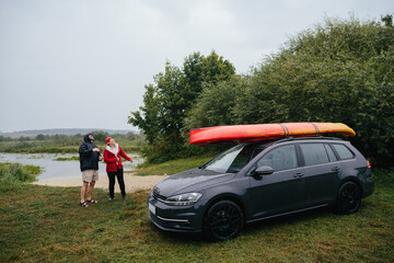Senior couple enjoying unexpected rain during kayaking trip