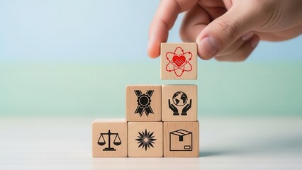 Hand stacking wooden blocks with esg and business values icons concept